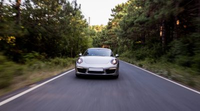 silver-color-coupe-with-front-lights-road